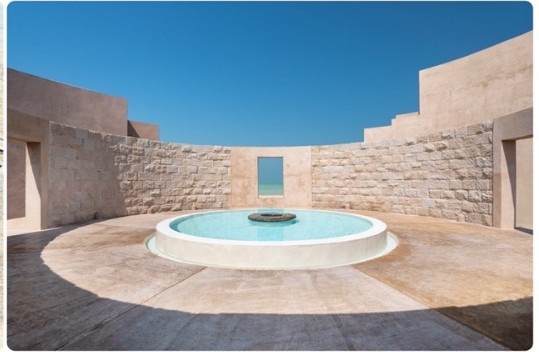 Circular stone courtyard with a central pool at Zulal Wellness Resort, Qatar